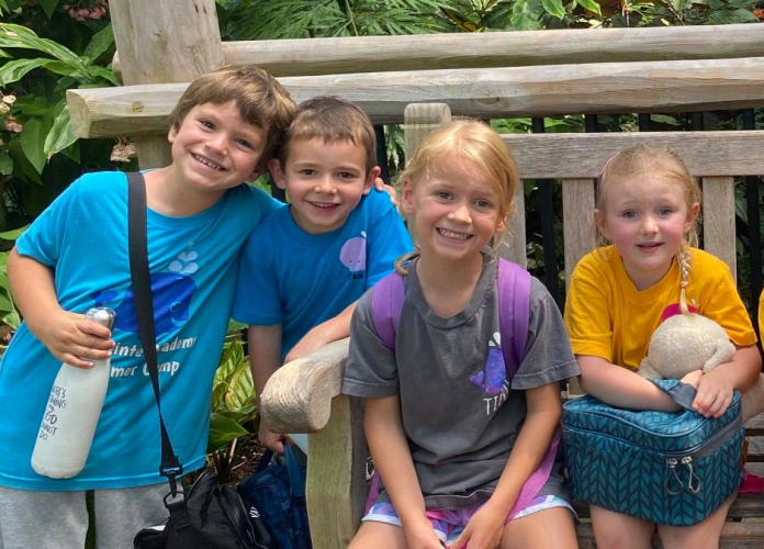 Group photo of students on a bench.