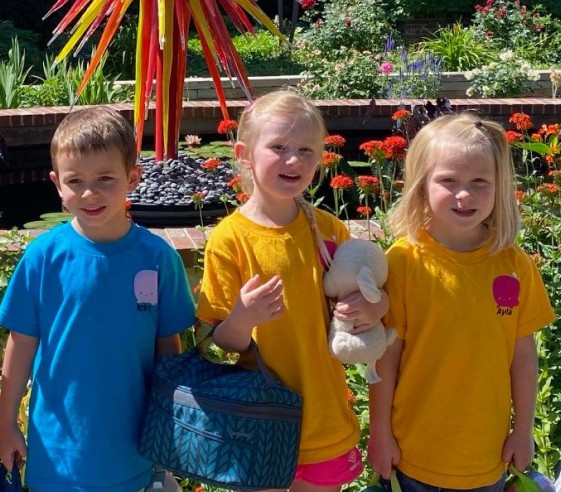 Kids outside posing for a photo.