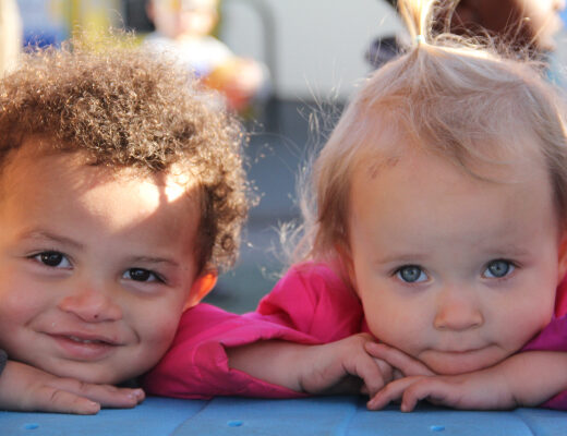 Two little kids looking directly at the camera.