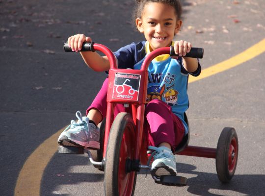 Little girl riding a bike.